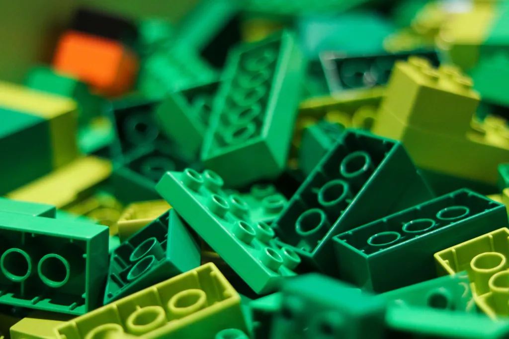 Alt text: Colorful pile of green LEGO bricks 