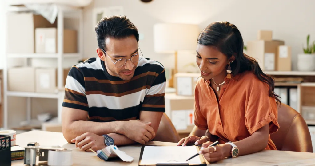 Two employees going through a checklist in an office. 
