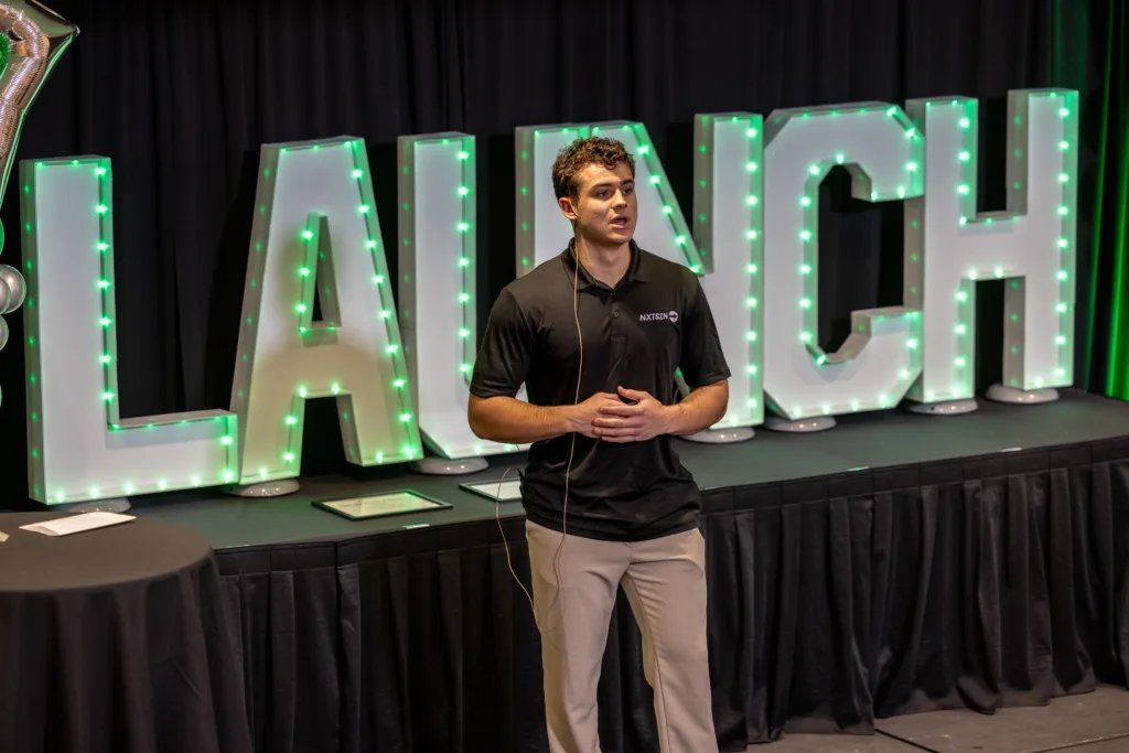 Man presenting on a stage.